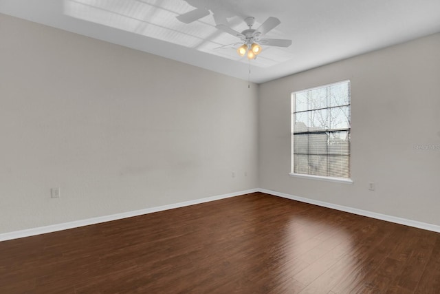 unfurnished room with dark hardwood / wood-style floors and ceiling fan