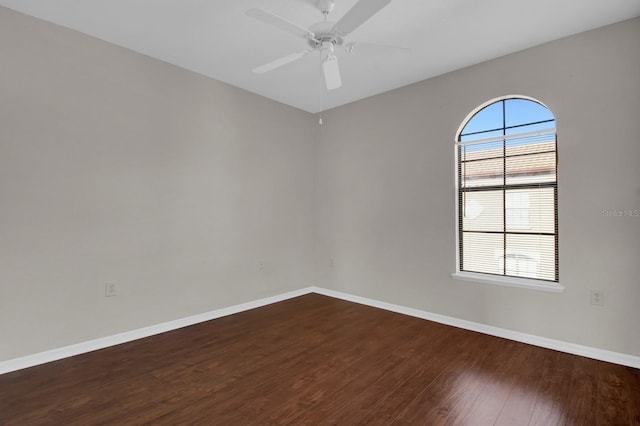 unfurnished room featuring ceiling fan and dark hardwood / wood-style flooring