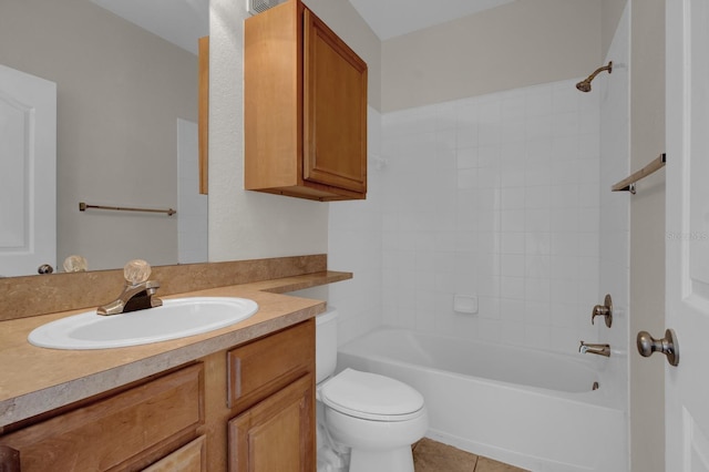 full bathroom featuring vanity, tile patterned flooring, tiled shower / bath combo, and toilet