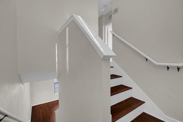 stairs featuring hardwood / wood-style flooring