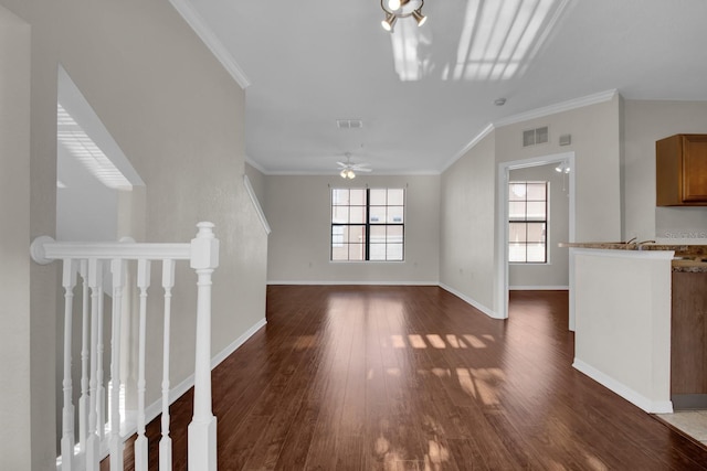 unfurnished living room featuring a wealth of natural light, ornamental molding, dark hardwood / wood-style floors, and ceiling fan