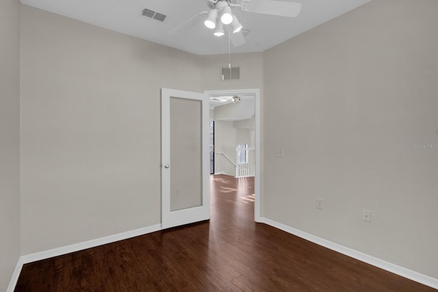 empty room with dark hardwood / wood-style flooring and ceiling fan