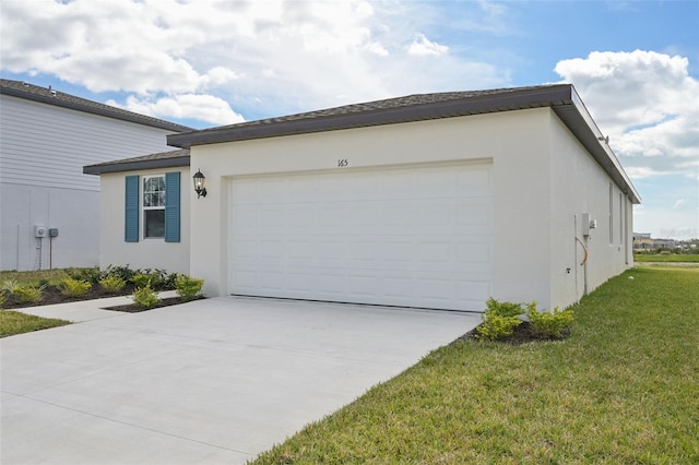 view of side of property featuring concrete driveway, a lawn, an attached garage, and stucco siding