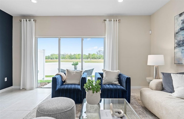 living room with plenty of natural light and light tile patterned floors