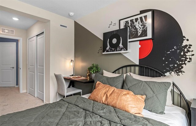 carpeted bedroom featuring vaulted ceiling and a closet