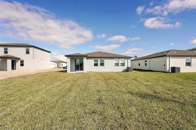 rear view of property with a yard and cooling unit