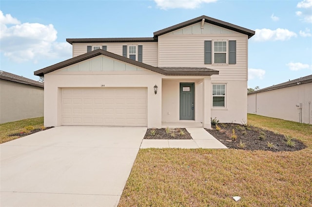 view of front of house with a garage and a front lawn