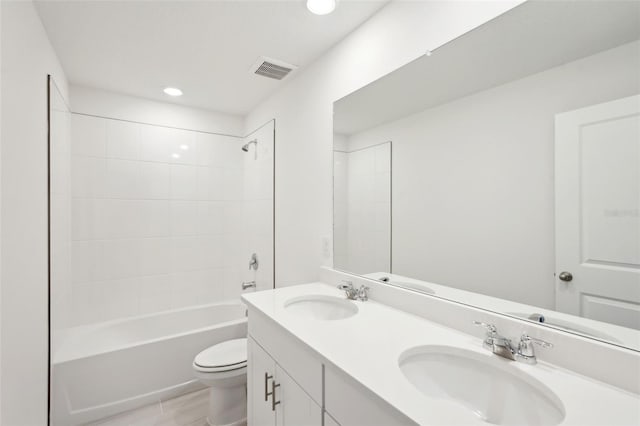 full bathroom with toilet, vanity, and tiled shower / bath