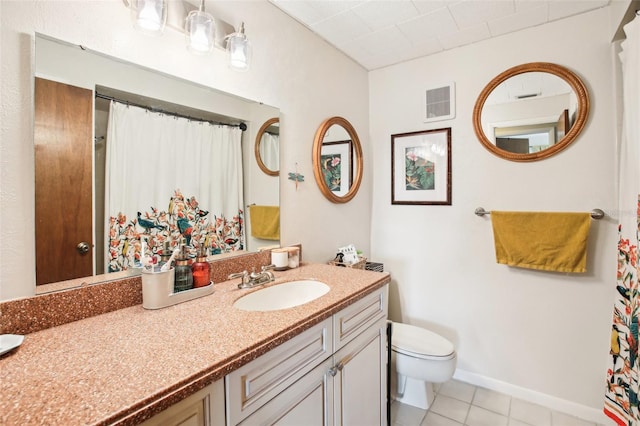 bathroom with vanity, toilet, and tile patterned floors