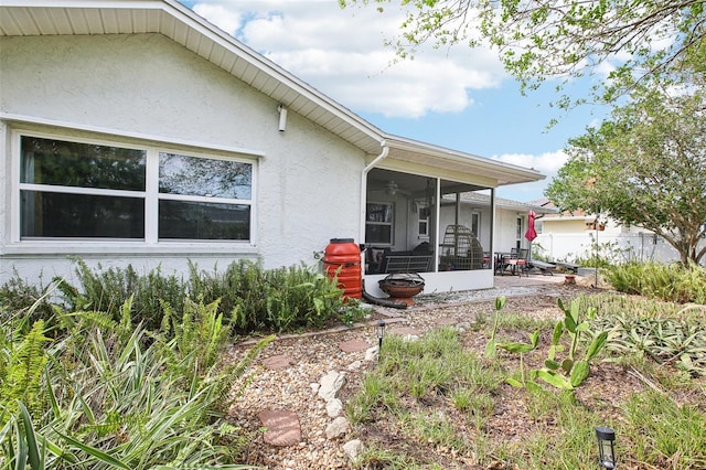 back of house featuring a sunroom