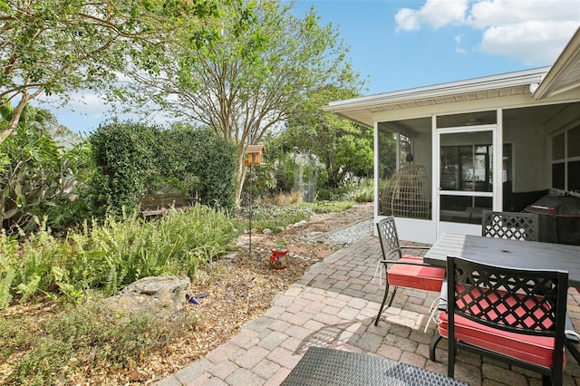 view of patio featuring a sunroom