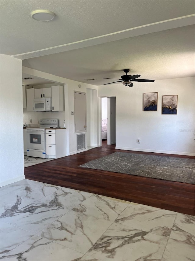 interior space with light hardwood / wood-style floors, a textured ceiling, and ceiling fan