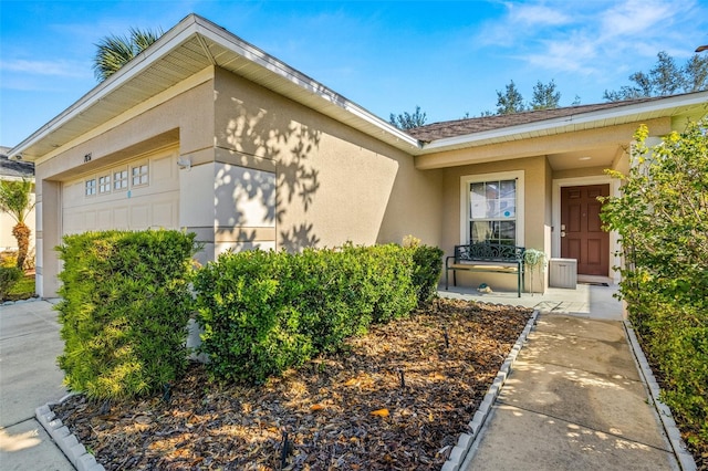 view of exterior entry with a garage