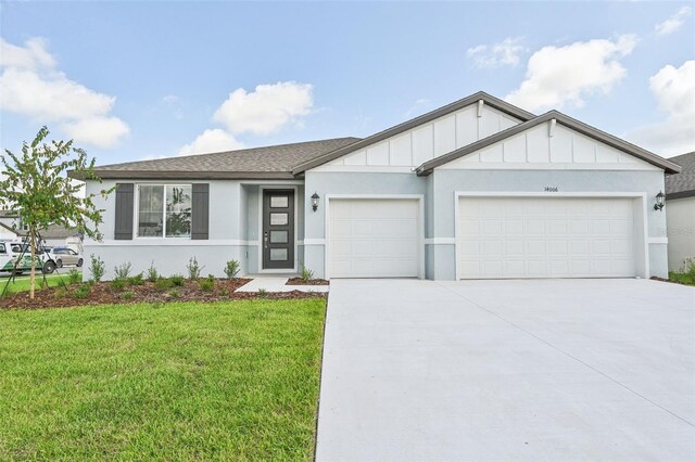 view of front of property with a garage and a front yard