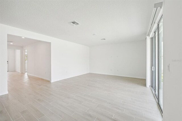 spare room with a textured ceiling