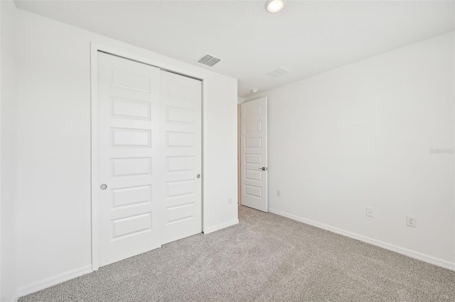 unfurnished bedroom featuring a closet and carpet