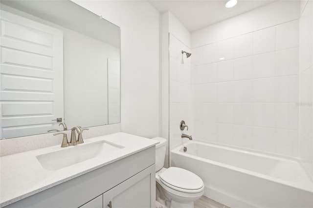 full bathroom featuring vanity, toilet, and tiled shower / bath