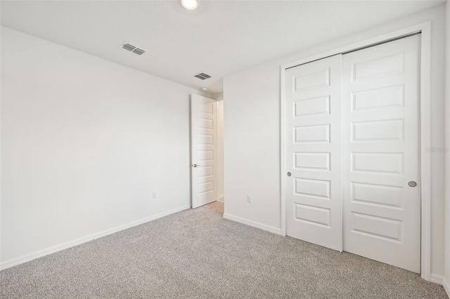 unfurnished bedroom with carpet floors and a closet