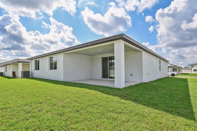 back of house featuring a yard, a patio, and central air condition unit