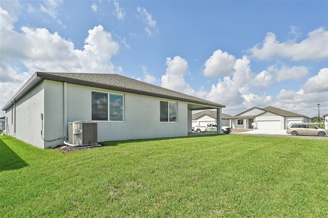 view of property exterior with central air condition unit and a yard