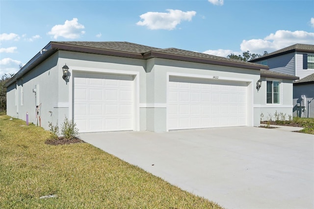 view of front of home with a front yard and a garage