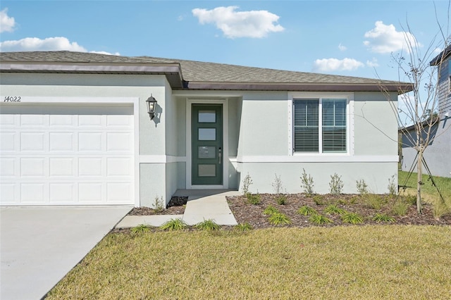 view of front of house with a garage and a front lawn