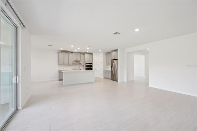 unfurnished living room featuring plenty of natural light