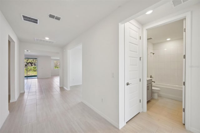 hall with light tile patterned floors