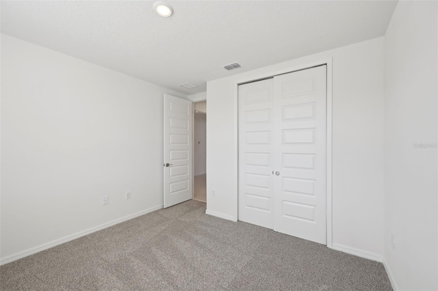 unfurnished bedroom with carpet and a closet