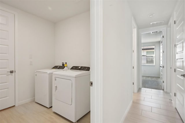 laundry room with light tile patterned floors and washing machine and dryer