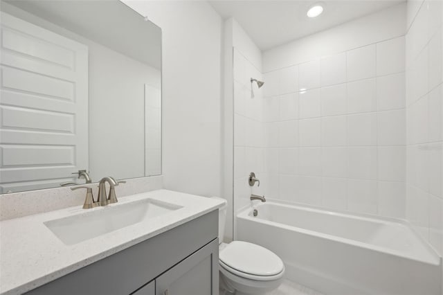 full bathroom featuring vanity, toilet, and tiled shower / bath