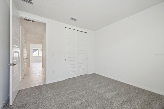 unfurnished bedroom featuring a closet and carpet