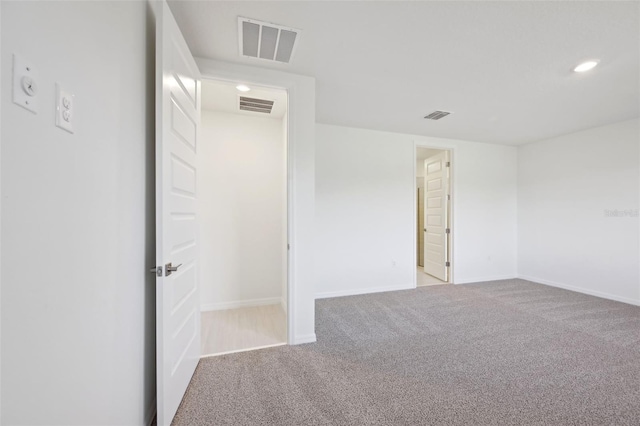 unfurnished room with light carpet