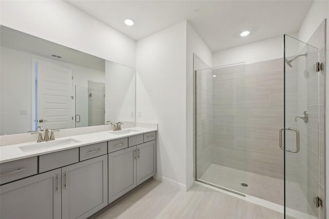 bathroom with vanity and a shower with shower door