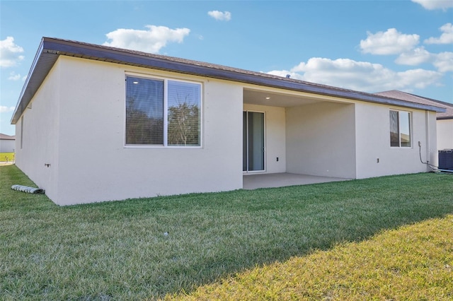 back of house featuring central AC unit, a yard, and a patio