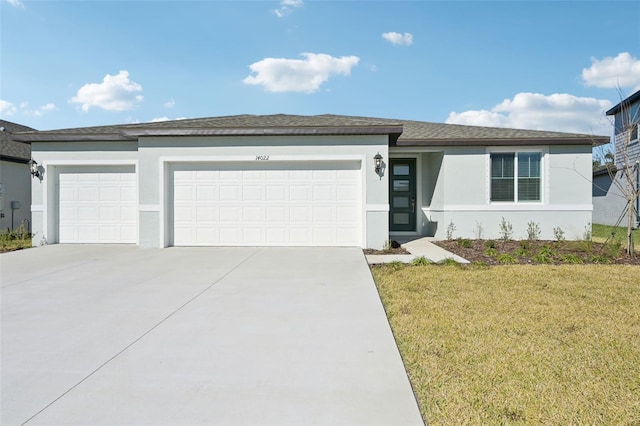 view of front facade with a garage and a front yard