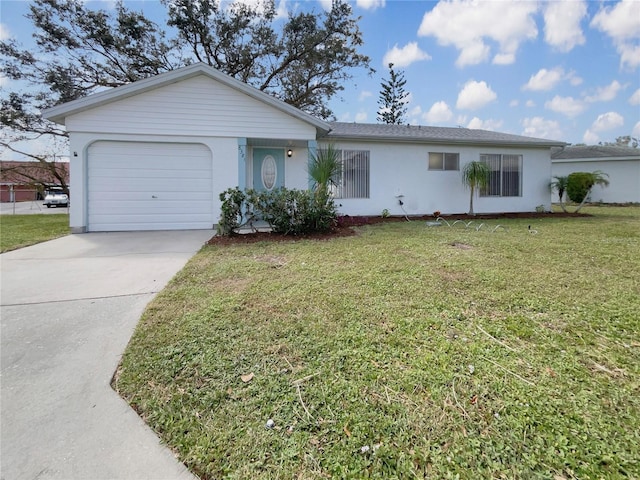 ranch-style home with an attached garage, driveway, a front yard, and stucco siding
