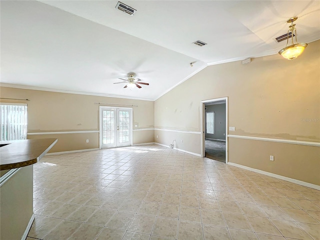 tiled empty room with lofted ceiling, french doors, ceiling fan, and crown molding