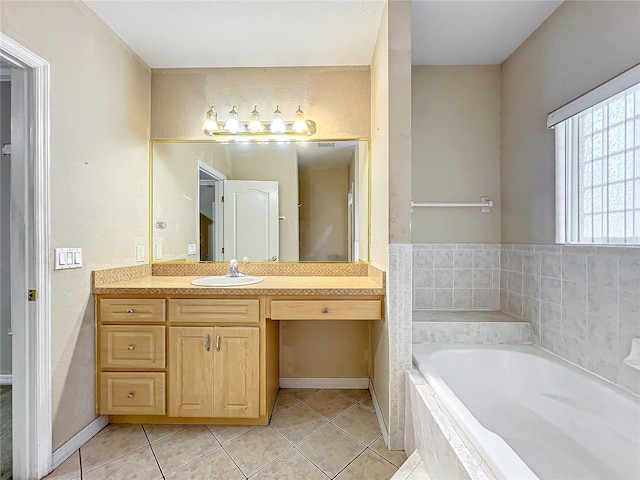 bathroom featuring vanity, tiled tub, and tile patterned floors