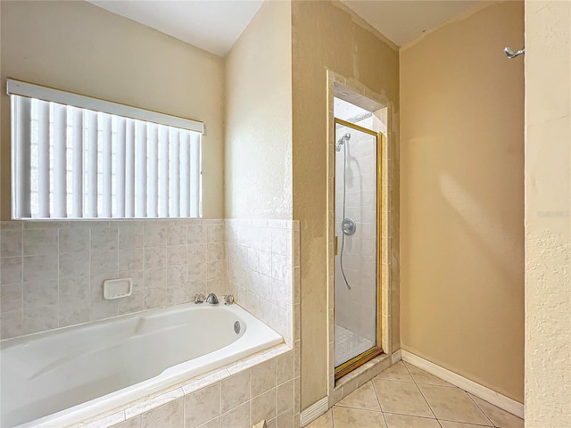 bathroom featuring independent shower and bath and tile patterned flooring