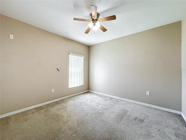 carpeted empty room with ceiling fan