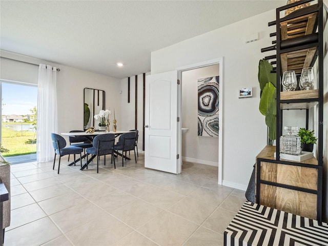 tiled dining space with a textured ceiling