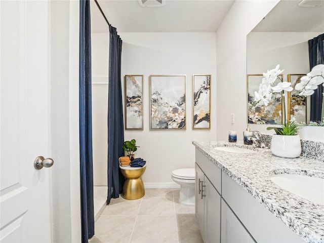 bathroom with toilet, walk in shower, vanity, and tile patterned flooring