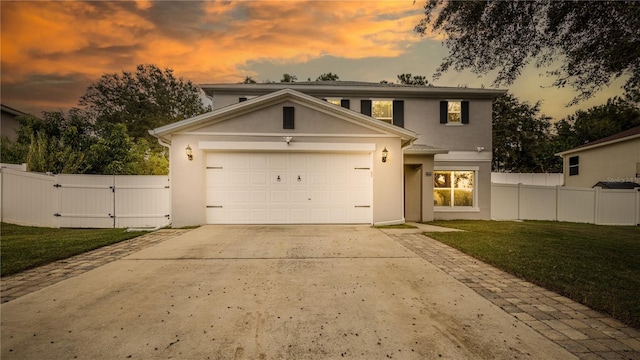 view of front of home featuring a yard and a garage