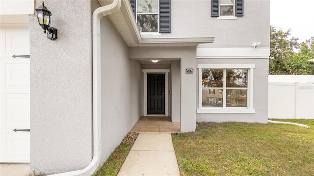 doorway to property featuring a yard