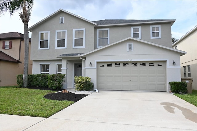 view of front of property with a front lawn and a garage