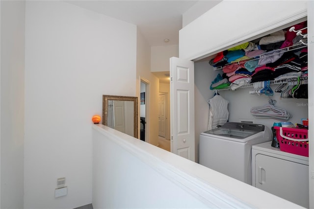 clothes washing area with washer and clothes dryer