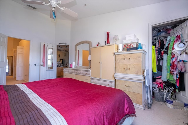 bedroom featuring light carpet, a closet, and ceiling fan