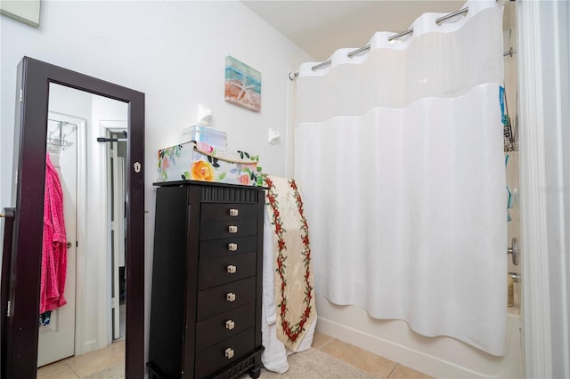 bathroom with tile patterned flooring and shower / bathtub combination with curtain