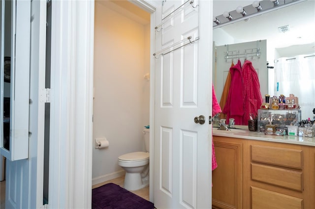 bathroom with vanity and toilet